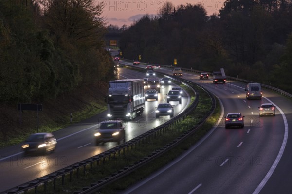 Evening scene on a motorway with heavy traffic, illuminated by headlights under a twilight sky, Rems-Murr district, Baden-Württemberg, Germany, Europe