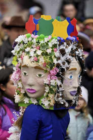 Person masked as a flower girl at the carnival parade of the Wey guild on Rose Monday, Güdismäntig, Lucerne Carnival 2024, Lucerne, Switzerland, Europe