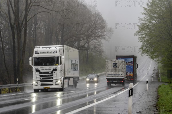 Traffic on a country road in the rain, B229, spring, near Radevormwalde, Oberbergischer Kreis, North Rhine-Westphalia, Germany, Europe