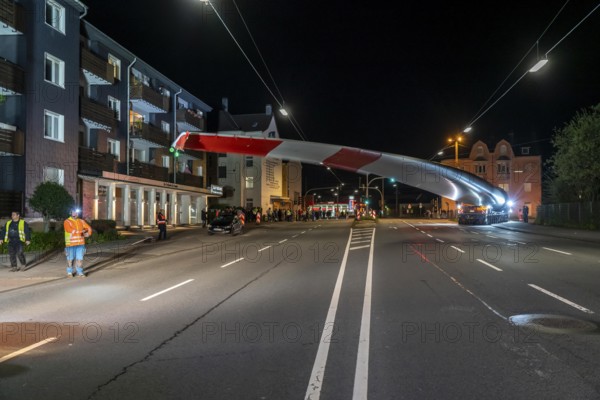 Transport of a 68 metre long, 22 tonne blade of a wind turbine, here in Schwelm, with a self-propelled Blade-Lifter vehicle, over a 40 km long route, over 2 nights, in the Bergisches Land, through towns, villages, over country roads, narrow through roads, to the construction site of the wind turbine near Hagen, North Rhine-Westphalia, Germany, Europe