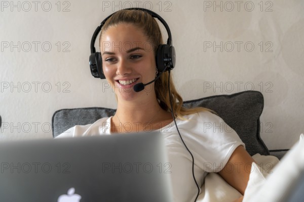 Young student learns at home, online, in conversation with other students