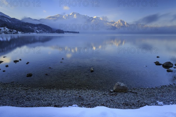 Mountains reflected in lake, morning light, fog, winter, snow, Lake Kochel, Alpine foothills, Bavaria, Germany, Europe