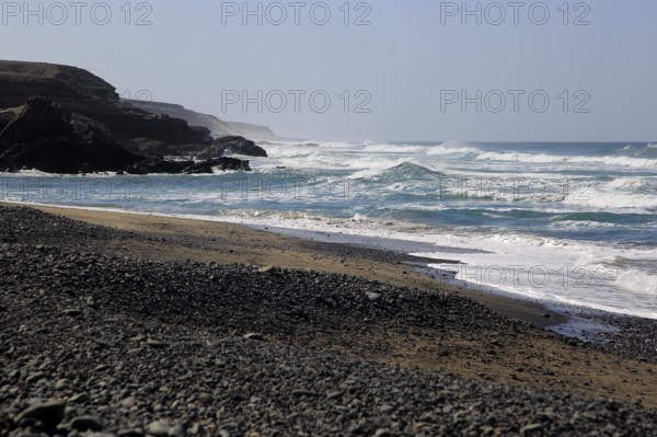 Waves breaking on beach at Playa de Garcey, Fuerteventura, Canary Islands, Spain, Europe