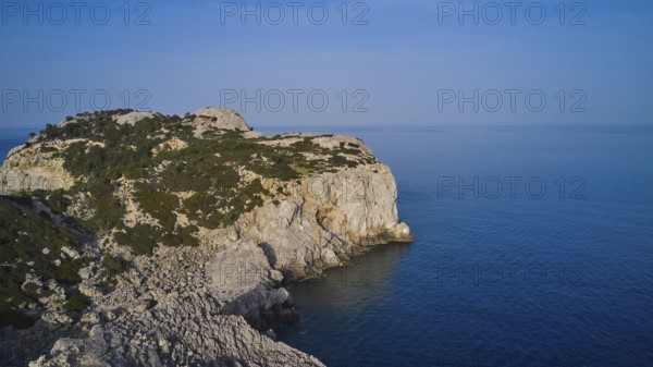 Drone shot, A rocky coastline with steep cliffs, calm sea and a clear blue sky, Anthony Quinn Bay, Vagies Bay, Rhodes, Dodecanese, Greek Islands, Greece, Europe