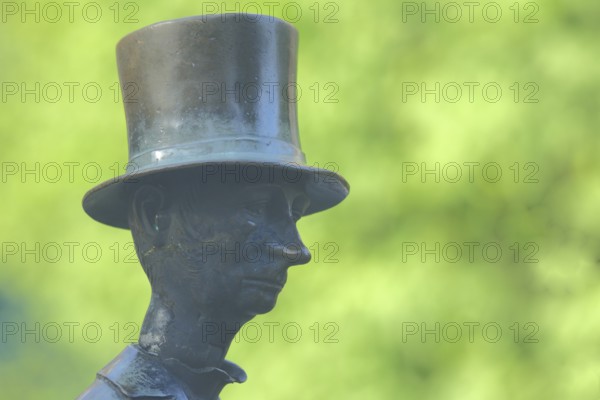 Man with top hat and historical Biedermeier clothing at the Datterich fountain, headgear, hat, bronze, sculpture, detail, face, nose, grey, green, funny, comical, Luisenplatz, Darmstadt, Bergstrasse, Hesse, Germany, Europe