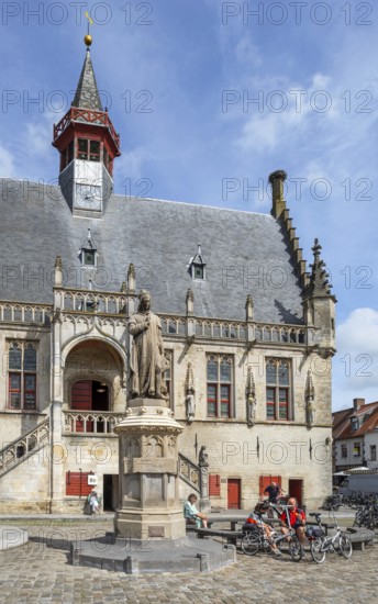 Statue of Jacob van Maerlant in front of Brabantine Gothic town hall in the city Damme in summer, West Flanders, Belgium, Europe