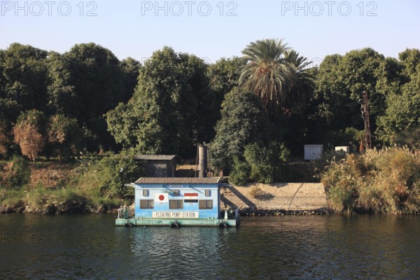 Floating pumping station, houses along the Nile, between Luxor and Esna, Africa, Upper Egypt