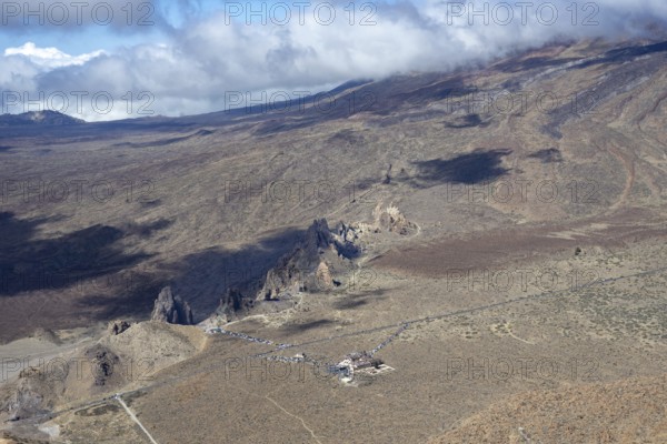 Panorama during the ascent to Alto de Guajara, 2715m, to the bizarrely shaped rock formations of volcanic rock, Roques de García, the visitor centre and the Hotel Parador, at sunrise, Teide National Park, Parque Nacional del Teide, Tenerife, Canary Islands, Spain, Europe