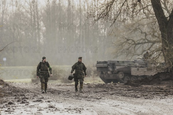Two soldiers walking on a muddy path, taken as part of the military exercise 'Wettiner Schwert' with German and Czech soldiers near Tangermünde, 26 March 2024. 'Wettiner Schwert' is part of the NATO Quadriga exercise