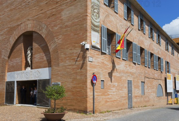 Red brick museum building with Spanish flag and sculptures at the entrance, Museo Nacional de Arte Romano, Museum, National Museum of Roman Art, Merida, Merida, Badajoz, Extremadura, Spain, Europe