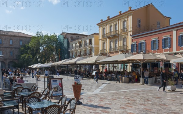 Busy square with cafés and parasols, surrounded by Mediterranean buildings, Syntagma Square, Nafplio, Nauplia, Nauplion, Nafplion, Argolis, Peloponnese, Greece, Europe