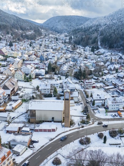 Urban winter landscape with snow-covered houses and church, Calmbach, Black Forest, Germany, Europe