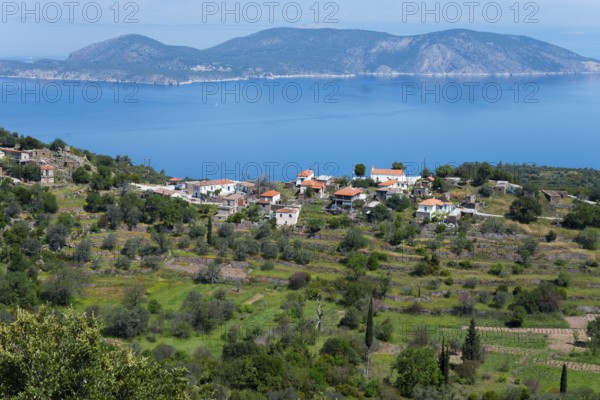 Coastal landscape with traditional houses and hills surrounded by blue sea and green vegetation, Makriloggos, Methana, peninsula in the Argolis on the Saronic Gulf, Attica, Peloponnese, Greece, Europe