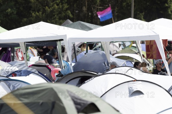 Adenau, Germany, 8 June 2024: Fans celebrate on one of the Rock am Ring campsites. The festival takes place at the Nürburgring race track near the town of Adenau from 7 to 9 June 2024, Europe