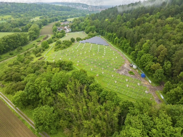 Aerial view of solar installations in a green landscape, surrounded by forest and fields, construction of the Black Forest Nature solar park, Weil der Stadt, Germany, Europe