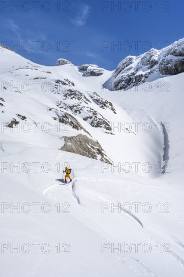 Lone ski tourer in mountain landscape with snow, ascent to Wildstrubelhütte, Bernese Alps, Switzerland, Europe
