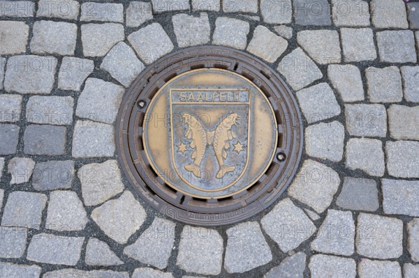 Municipal manhole cover with the coat of arms of Saalfeld, Kulmbach, Upper Franconia, Bavaria, Germany, Europe