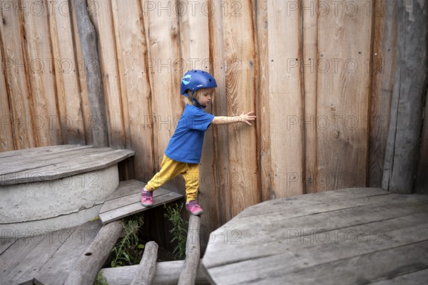 Little girl, 3 years, blonde, helmet, helmet, balancing, gymnastics, playing, adventure playground, playground, Stuttgart, Baden-Württemberg, Germany, Europe