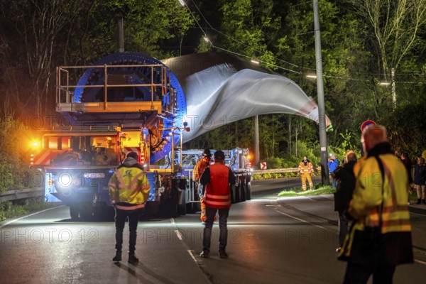 Transport of a 68 metre long, 22 tonne blade of a wind turbine, here in Schwelm, with a self-propelled Blade-Lifter vehicle, over a 40 km long route, over 2 nights, in the Bergisches Land, through towns, villages, over country roads, narrow through roads, to the construction site of the wind turbine near Hagen, North Rhine-Westphalia, Germany, Europe