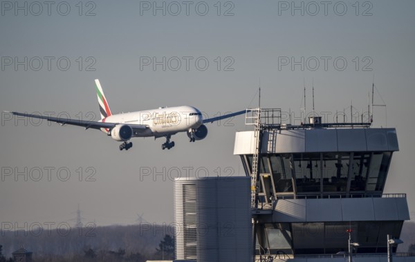 Emirates, Boeing 777, aircraft approaching Düsseldorf Airport, DUS, old air traffic control tower, North Rhine-Westphalia, Germany, Europe