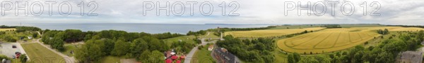 Panorama of a coastal landscape with fields and a distant sea view, Rügen