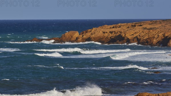 Rippled sea surface along a rocky coastline under a clear sky, west coast, Karpathos, Dodecanese, Greek Islands, Greece, Europe