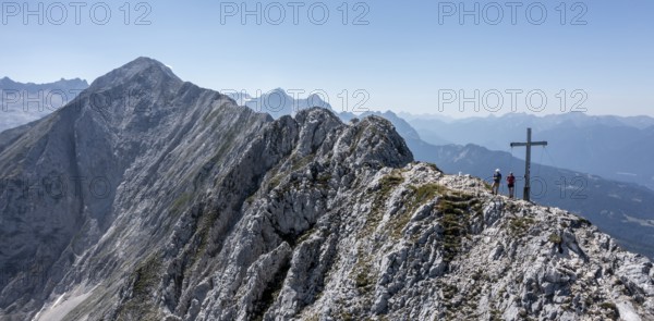 Aerial view, Alpine panorama, hikers at the summit cross, Westliche Wettersteinspitze, Wetterstein Mountains, Bavaria, Germany, Europe