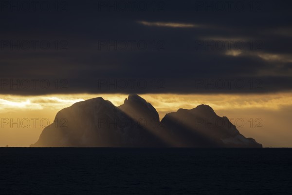 Island Værøy at the southern end of Lofoten under clouds with sunrays