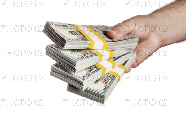 Creative business finance making money concept, hand holding stack of bundles of 100 US dollars 2013 edition banknotes bills isolated on white