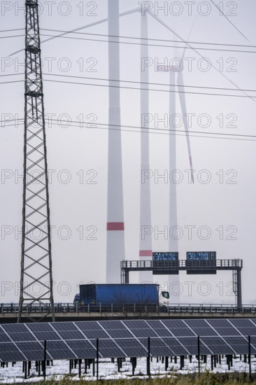 Wind farm in the fog, photovoltaic system, on the A44 motorway, dark doldrums, no wind no direct sunlight, in the Rhenish lignite mining area, south of the Garzweiler opencast mine near Bedburg, North Rhine-Westphalia, Germany, Europe