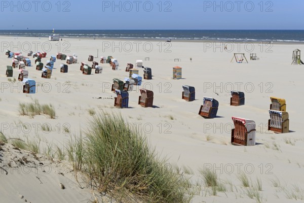 Colourful beach chairs on the beach, blue sky, North Sea, Island of Juist, East Frisian Islands, Lower Saxony, Germany, Europe