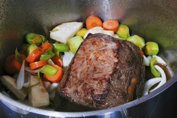 Swabian cuisine, preparation cider roast, roast ox in cooking pot, vegetables, roast, meat dish, savoury, salty, typical Swabian, home cooking, traditional cuisine, food photography, studio, Germany, Europe