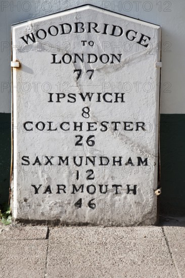 Old mile post marker with distances, Woodbridge, Suffolk, England, United Kingdom, Europe