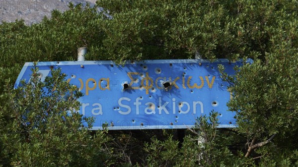 Signpost, Chora Sfakion, bullet holes, Frangokastello, Venetian fortress, castle, Sfakia, West Crete, south coast, island of Crete, Greece, Europe