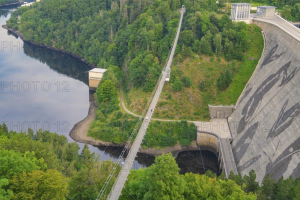 View of a bridge crossing a dam surrounded by dense forest and a calm body of water, Rappbodetalsperre, Harz Mountains, Germany, Europe