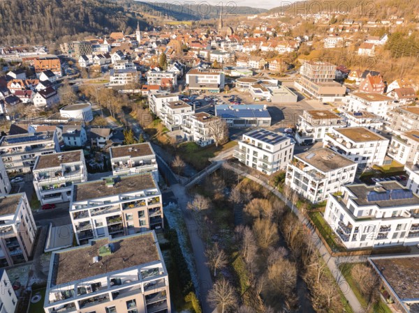 Houses and buildings in a wintry town against a hilly backdrop, Nagold, Black Forest, Germany, Europe