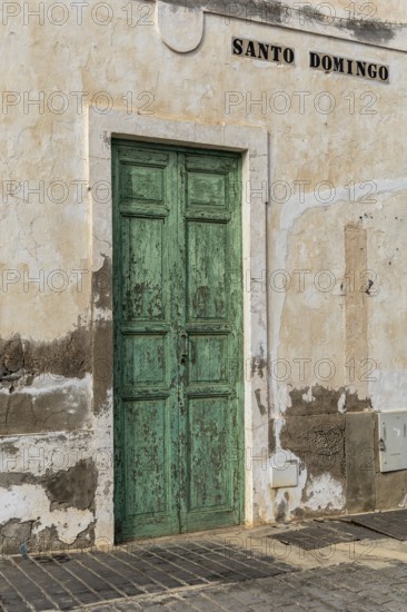 Weathered green door in an old building wall with the lettering 'Santo Domingo', Canary Islands, Lanzarote, Spain, Europe