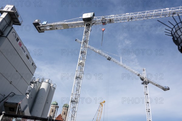 Construction cranes stand on the construction site for the major project 2 of the Munich S-Bahn main line, behind them the towers of the Church of Our Lady, Munich, Bavaria, Germany, Europe