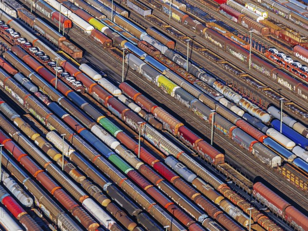 Deutsche Bahn AG marshalling yard. Many goods trains are parked on the tracks with tank wagons, car transporters and other wagons, companies transport a considerable part of their freight by rail, aerial view, Germany, Europe