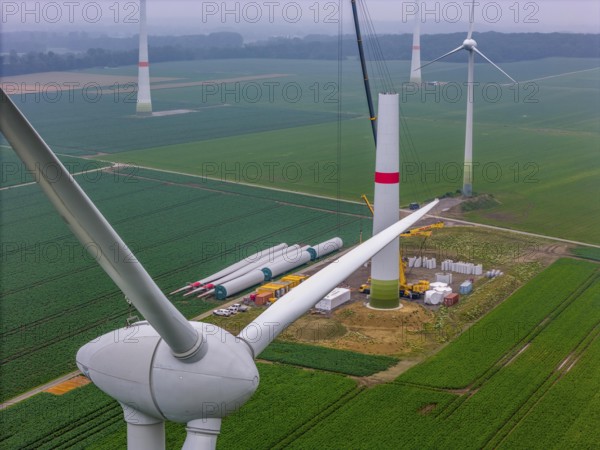 Erection of the tower of a wind power plant in a wind farm near Issum, 9 older wind turbines from the manufacturer Enercon (model series E-58) at the rear right and front, which have been in operation for over two decades, will be replaced by a total of four Enercon E-160 turbines, under construction, with a total output of 22 megawatts, Lower Rhine, North Rhine-Westphalia, Germany, Europe