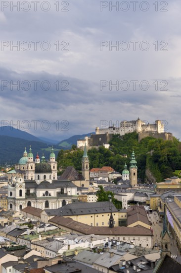 High-format photograph of the historic centre of Salzburg with the Hohensalzburg Fortress under a cloudy sky, Salzburg, Salzburger Land, Austria, Europe