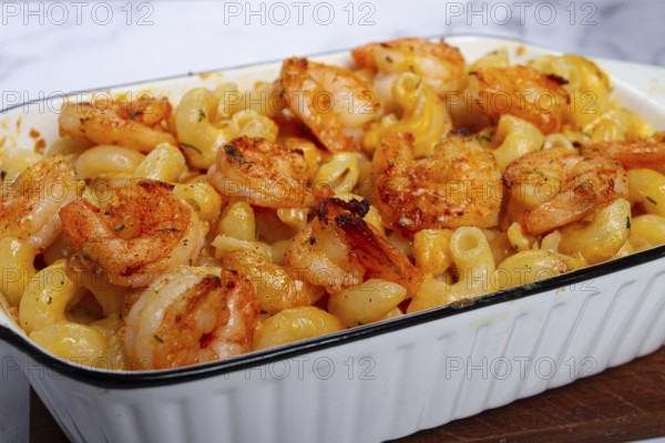 Pasta with shrimp and cheese, with a golden crust, cooked in a baking dish, homemade, no people