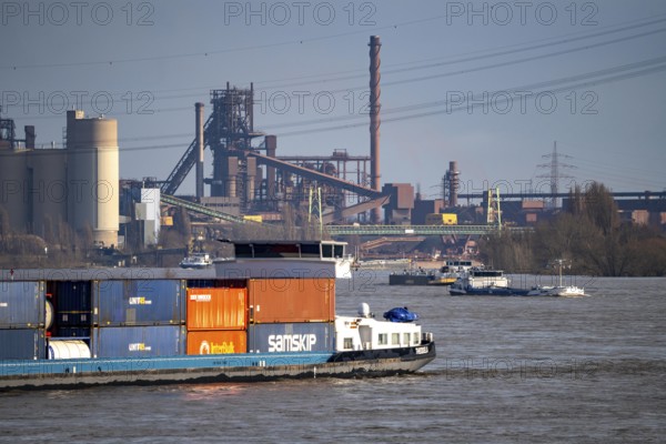 The Rhine near Duisburg, cargo ships, backdrop of the ThyssenKrupp Steel steelworks in Duisburg Marxloh, blast furnace Schwelgern 1, North Rhine-Westphalia, Germany, Europe