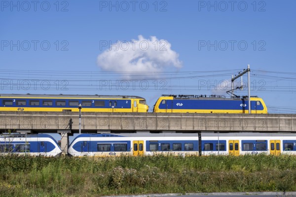 Trains of the Dutch railway, NS, Nederlandse Spoorwegen N.V., on a double-decker track, below local train Sprinter Light Train, above Intercity Direct train, near Hoofddorp, municipality of Haarlemmermeer, near Amsterdam