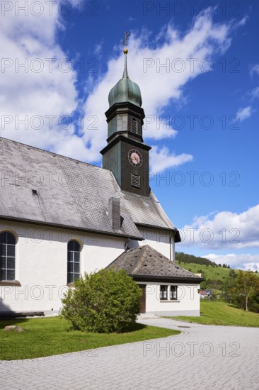 Church tower of St. Johann Church under a blue sky with cumulus clouds in the Innerlehen district, Bernau im Black Forest, Black Forest, Waldshut district, Baden-Württemberg, Germany, Europe