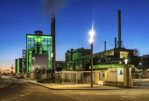 The Lausward combined heat and power plant in Düsseldorf, gas and steam turbine power plant, operated by Stadtwerke Düsseldorf and EnBW, in the harbour of Düsseldorf on the Rhine, green illuminated city window, the chimney of the Fortuna power plant unit, the power plant generates electricity, also traction current and district heating, North Rhine-Westphalia, Germany, Europe