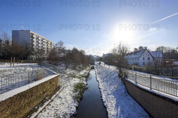 Dortmund, North Rhine-Westphalia, Germany, winter with snow in the Ruhr area, renaturalised Emscher in Dortmund-Aplerbeck at the moated castle Haus Rodenberg (right), Europe