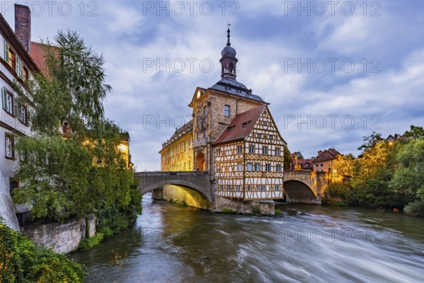 Old Town Hall on an artificial island in the River Regnitz. The landmark can be reached via two arched bridges. Night shot. City view of Bamberg, Upper Franconia, Bavaria, Germany, Europe