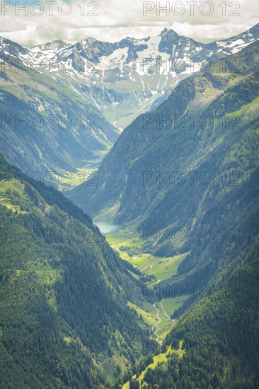 Breathtaking alpine valley with snow-capped mountains and lush green meadows, Stilluptal, Zillertal. Austria