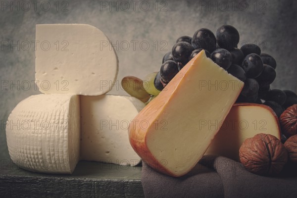 Georgian cheese, Imeretian and smoked suluguni, grapes, nuts, on a cutting board, Georgian cuisine, no people